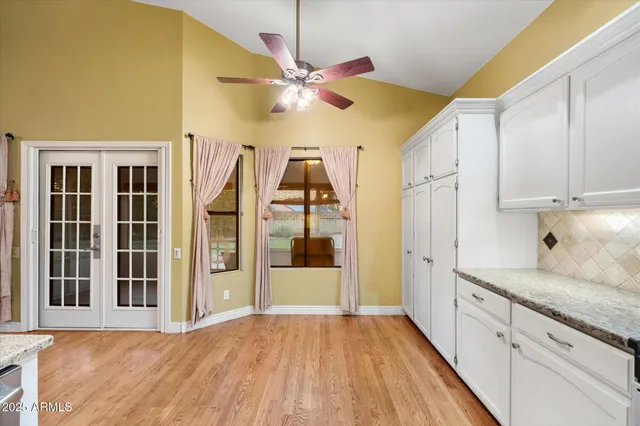 a view of a house with a patio and a yard