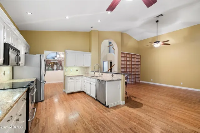 an aerial view of multiple houses with a city view