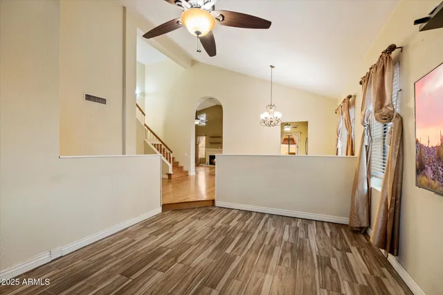 a view of a livingroom with a fireplace wooden floor and a window