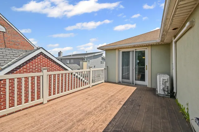 a view of backyard with a deck and wooden floor