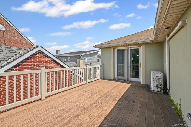 a view of backyard with a deck and wooden floor