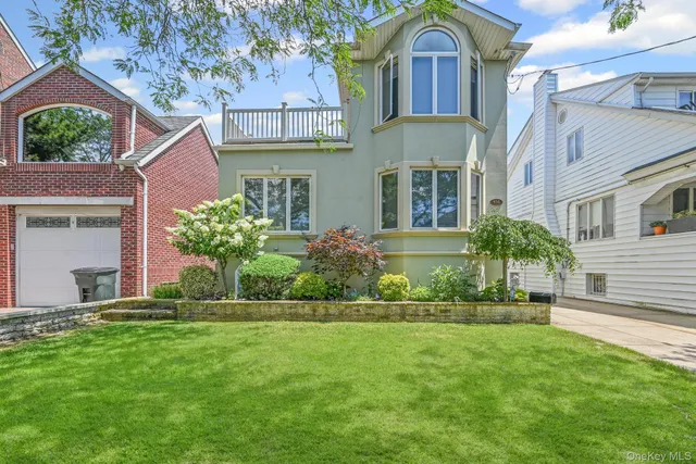 a front view of a house with a garden