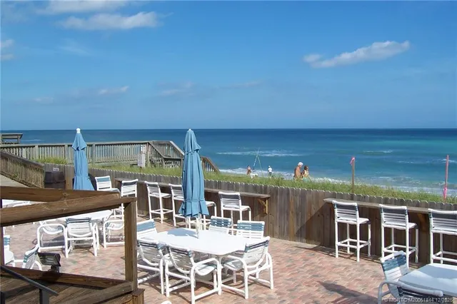 a view of swimming pool with outdoor seating and city in back