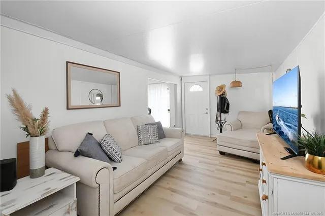 a living room with furniture and a mirror