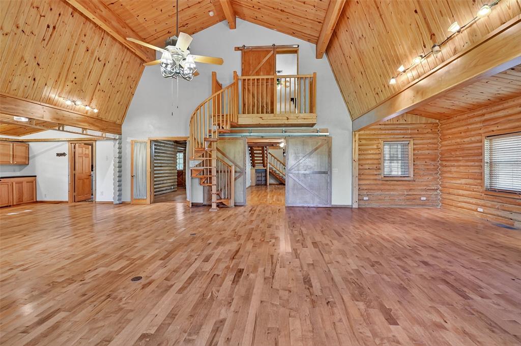 570 Ayres Road Bells, TX 75414 - Photo 12 of 39 Unfurnished living room with high vaulted ceiling, light wood finished floors, a wood ceiling with exposed beams, ceiling fan, and stairs