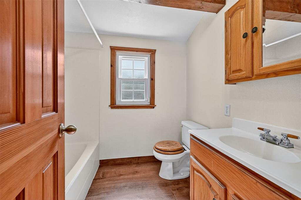 570 Ayres Road Bells, TX 75414 - Photo 34 of 39 Bathroom featuring vanity and wood finished floors