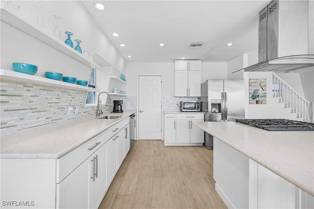 3128 Stringfellow Road St. James City, FL 33956 - Photo 11 of 50 a large kitchen with stainless steel appliances lots of counter top space