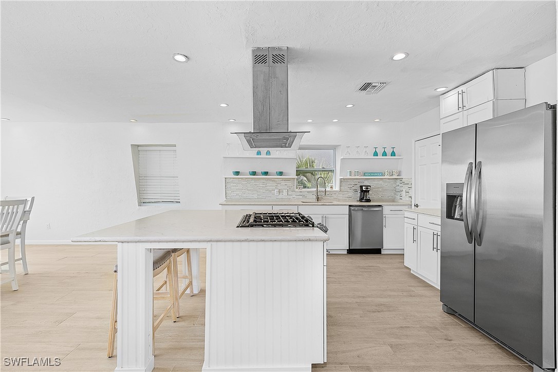 3128 Stringfellow Road St. James City, FL 33956 - Photo 12 of 50 a kitchen with a white stainless steel appliances cabinets and a counter top space