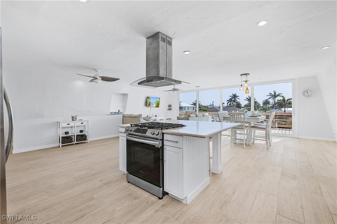 3128 Stringfellow Road St. James City, FL 33956 - Photo 13 of 50 a kitchen with stainless steel appliances a stove top oven and cabinets