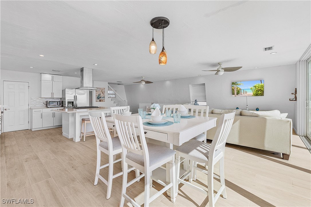 3128 Stringfellow Road St. James City, FL 33956 - Photo 19 of 50 a kitchen with stainless steel appliances kitchen island granite countertop a sink and cabinets