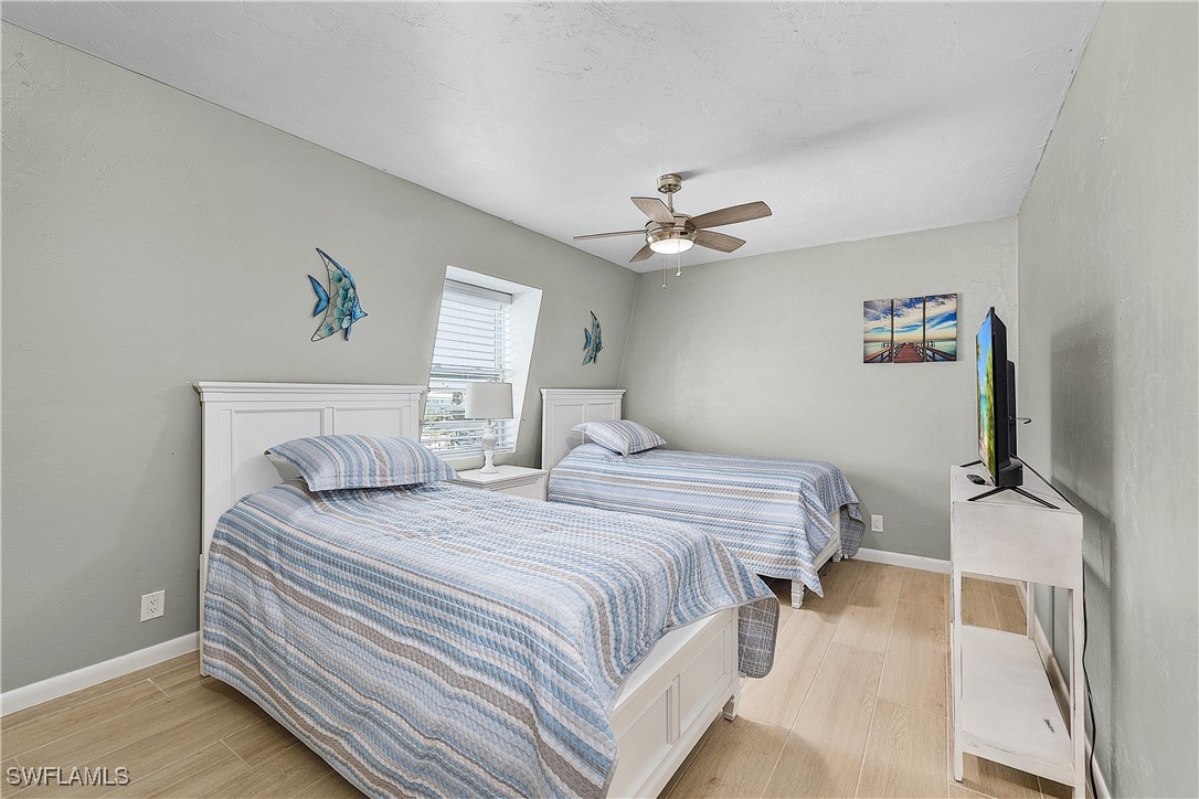 3128 Stringfellow Road St. James City, FL 33956 - Photo 24 of 50 a bedroom with a bed and a chandelier