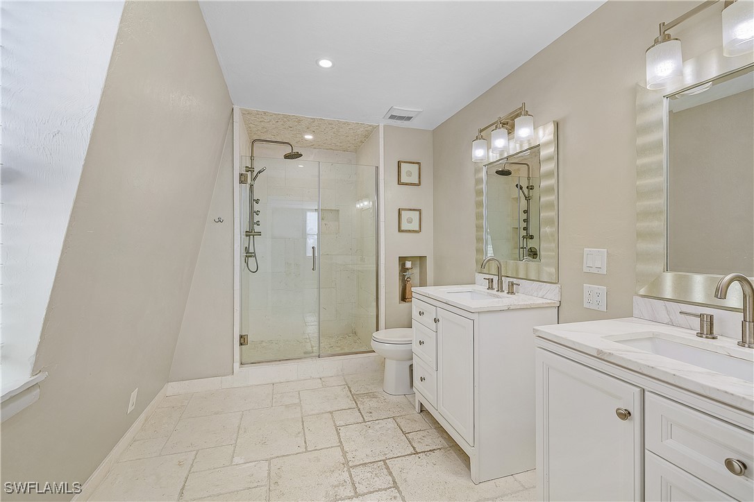 3128 Stringfellow Road St. James City, FL 33956 - Photo 25 of 50 a spacious bathroom with a shower sink and mirror