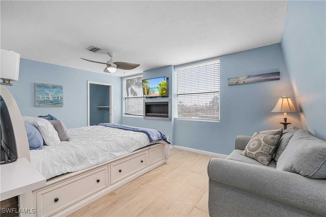 3128 Stringfellow Road St. James City, FL 33956 - Photo 26 of 50 a bedroom with a large bed and a couch