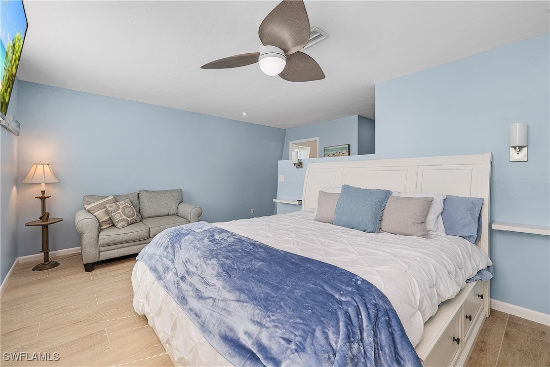 3128 Stringfellow Road St. James City, FL 33956 - Photo 28 of 50 a bedroom with a bed and a chandelier