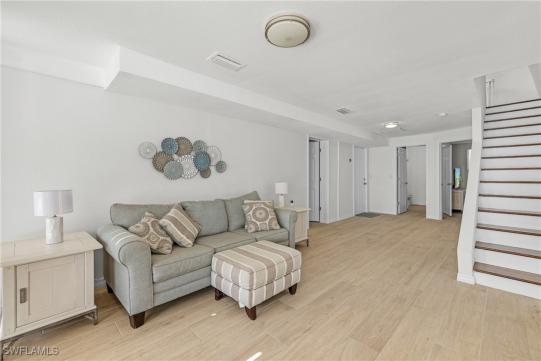 3128 Stringfellow Road St. James City, FL 33956 - Photo 33 of 50 a living room with furniture and a night stand