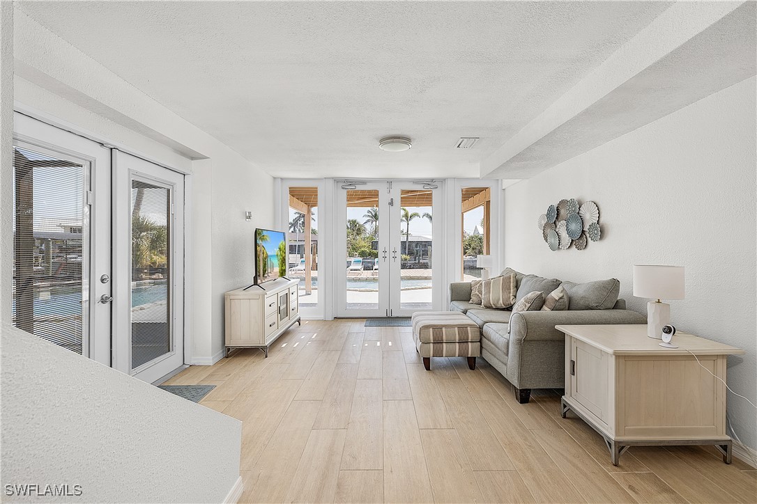 3128 Stringfellow Road St. James City, FL 33956 - Photo 35 of 50 a living room with furniture and a large window