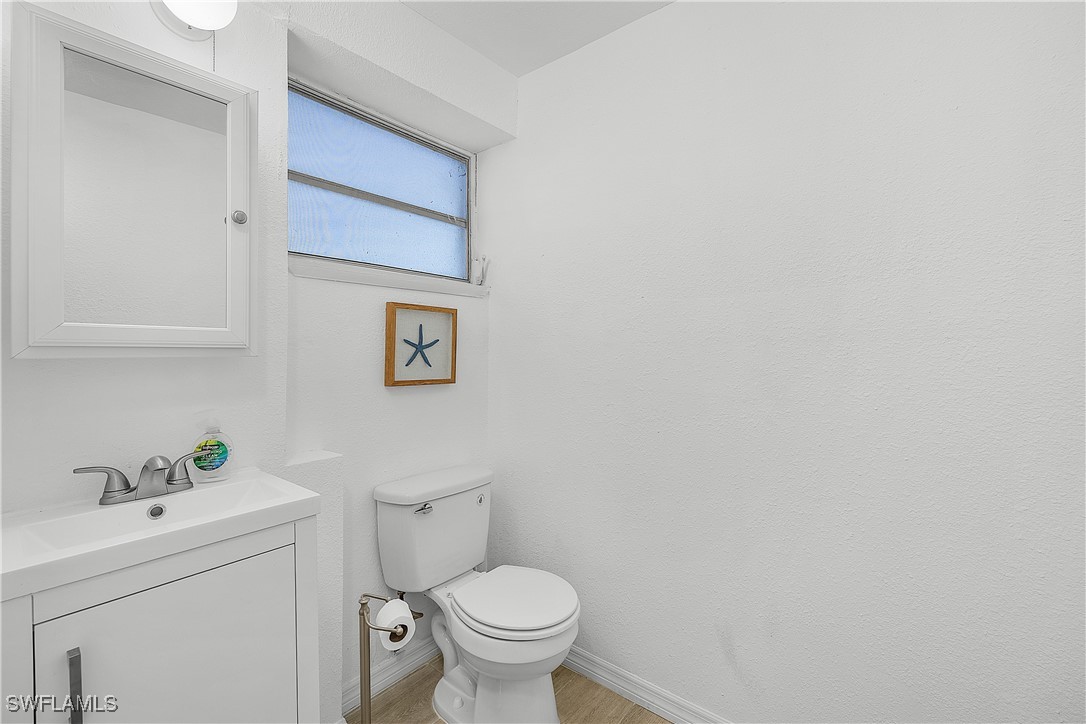 3128 Stringfellow Road St. James City, FL 33956 - Photo 37 of 50 a white toilet sitting next to a bathroom sink