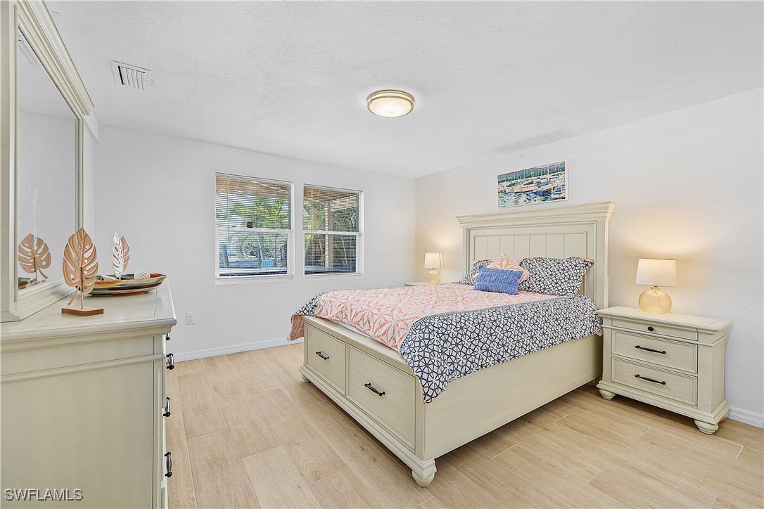 3128 Stringfellow Road St. James City, FL 33956 - Photo 38 of 50 a bedroom with a bed and a window