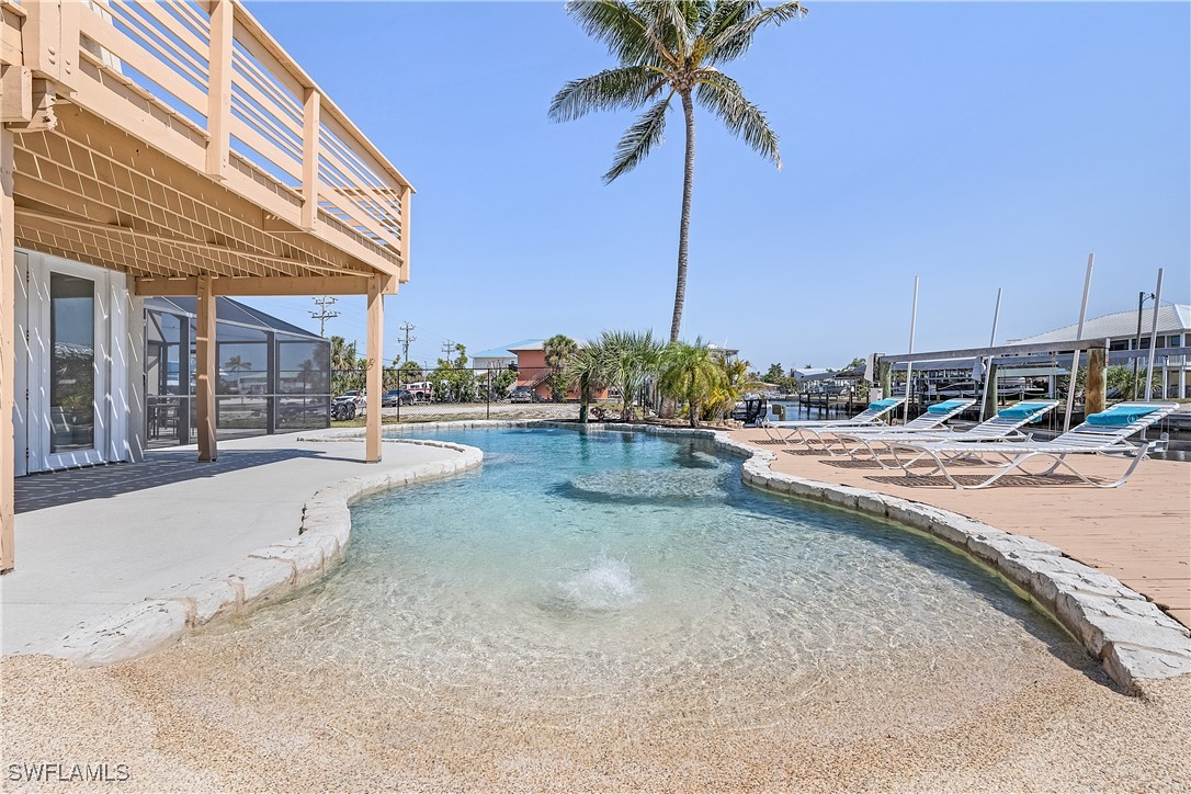 3128 Stringfellow Road St. James City, FL 33956 - Photo 41 of 50 a view of a swimming pool with a chair