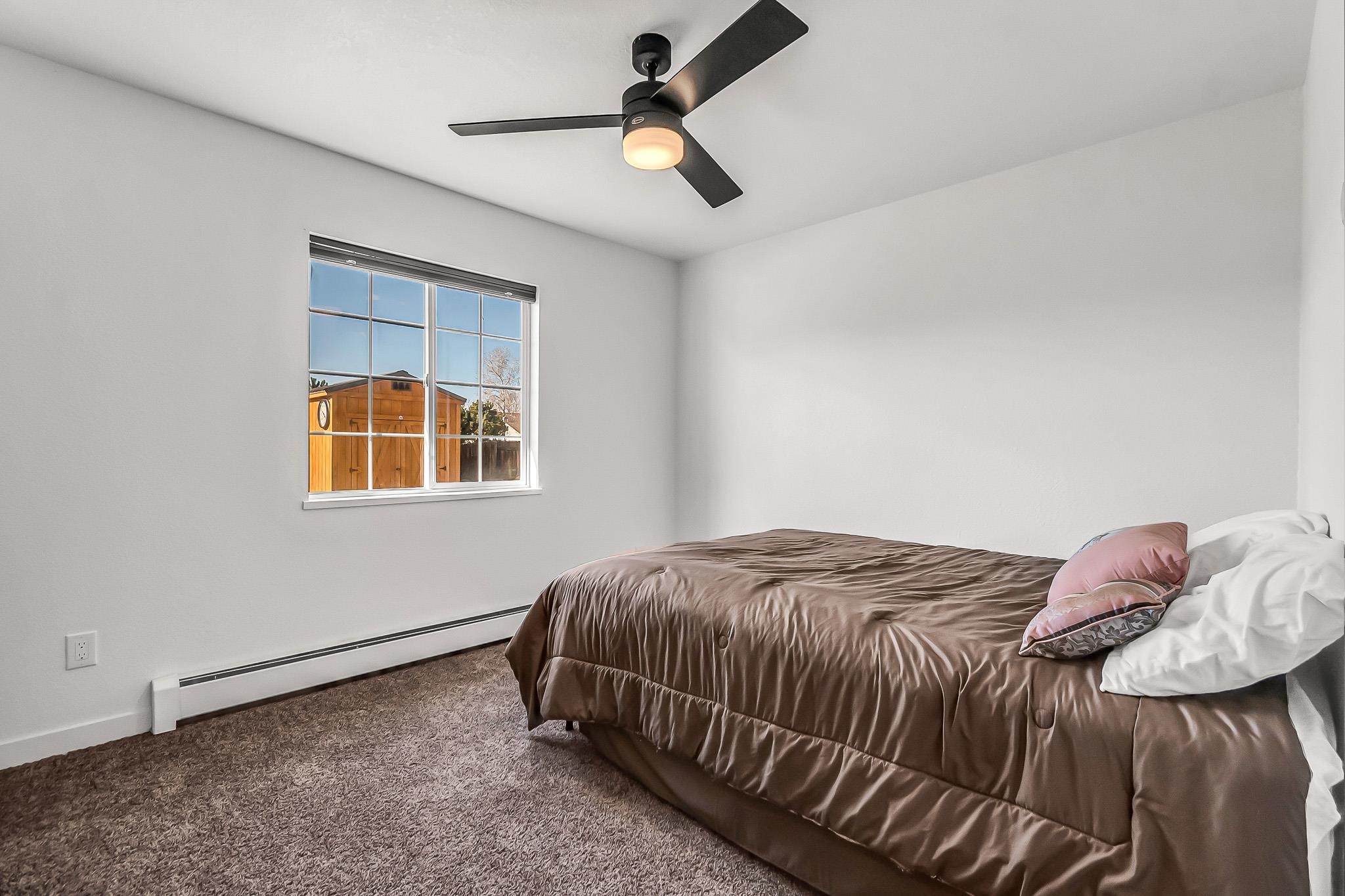 505 North Oak Street Fruita, CO 81521 - Photo 12 of 21 a bedroom with a bed and a window