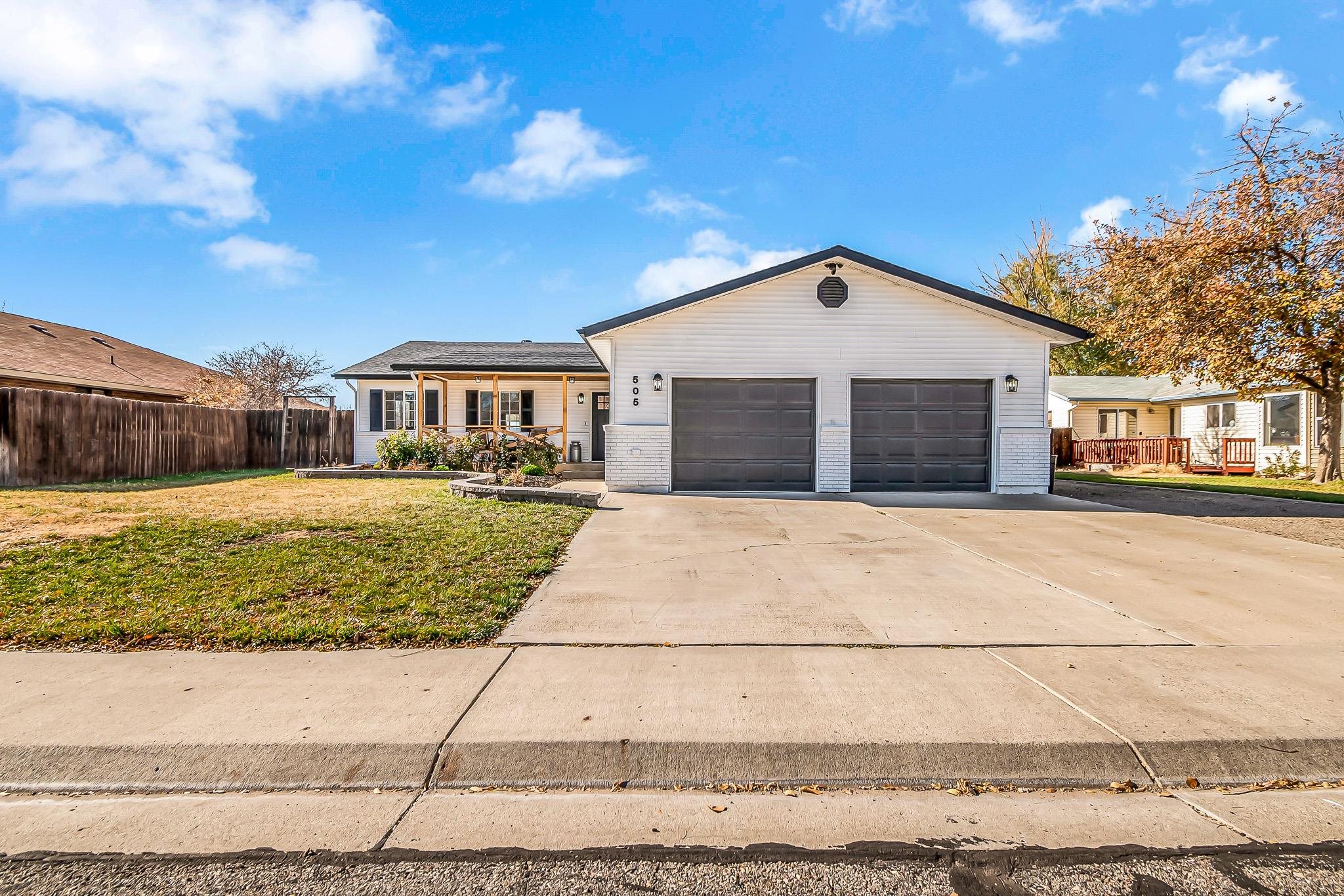 505 North Oak Street Fruita, CO 81521 - Photo 2 of 21 a front view of a house with a yard