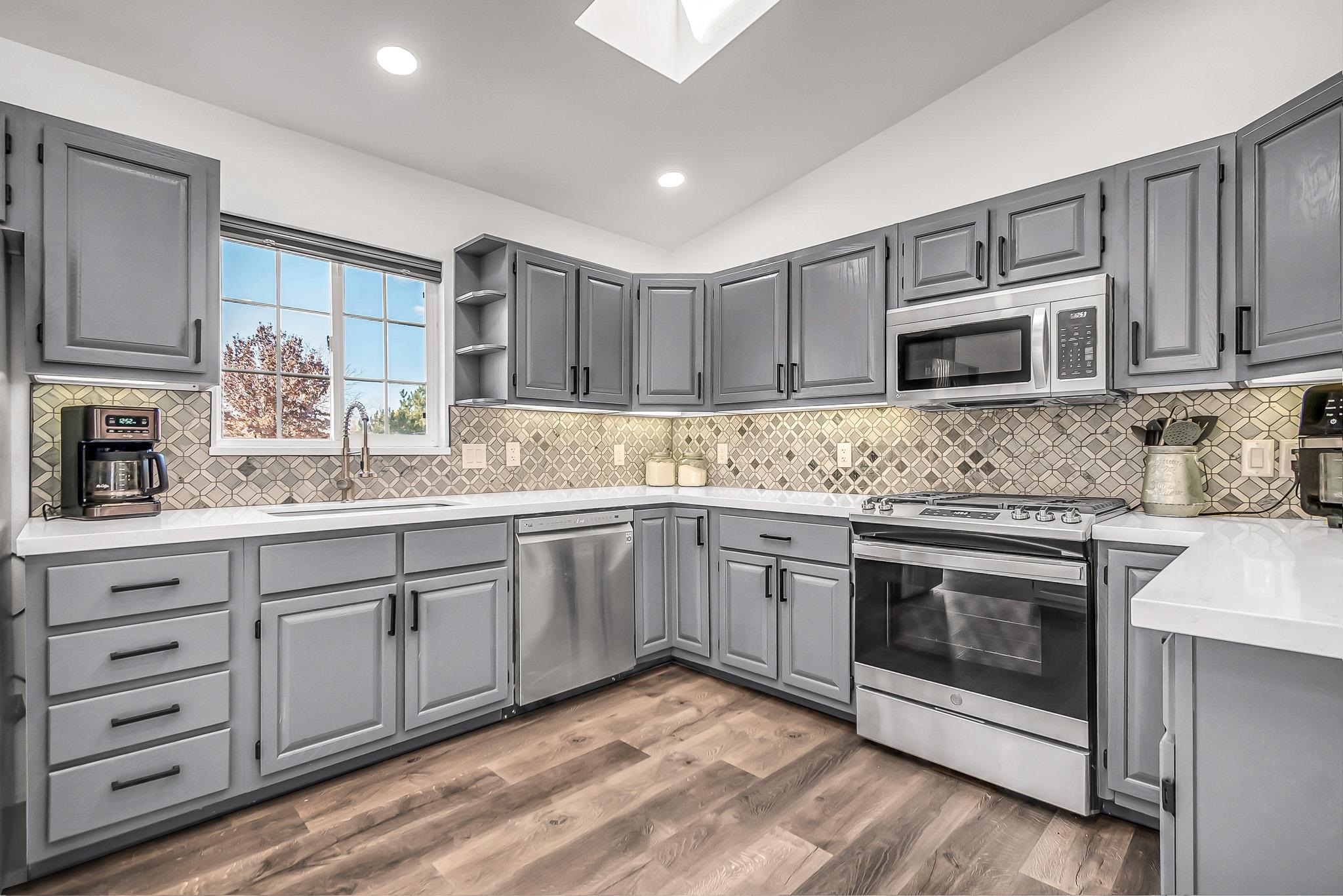 505 North Oak Street Fruita, CO 81521 - Photo 9 of 21 a kitchen with stainless steel appliances granite countertop a stove cabinets and microwave