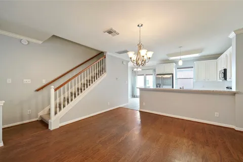 a view of a room with wooden floor and staircase