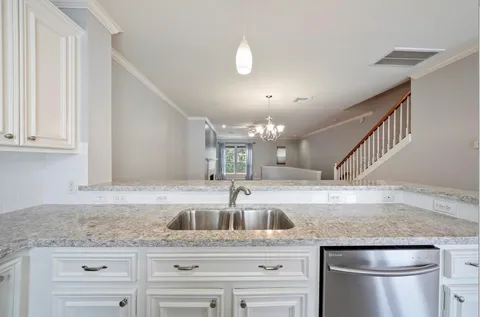 a kitchen with granite countertop a sink and cabinets