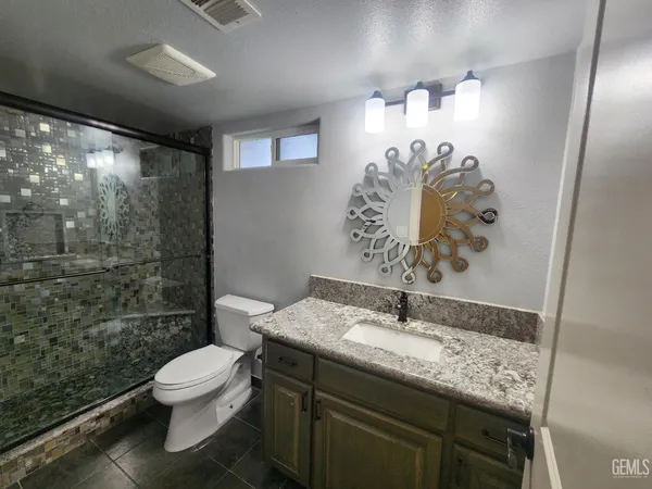 a bathroom with a sink toilet and shower
