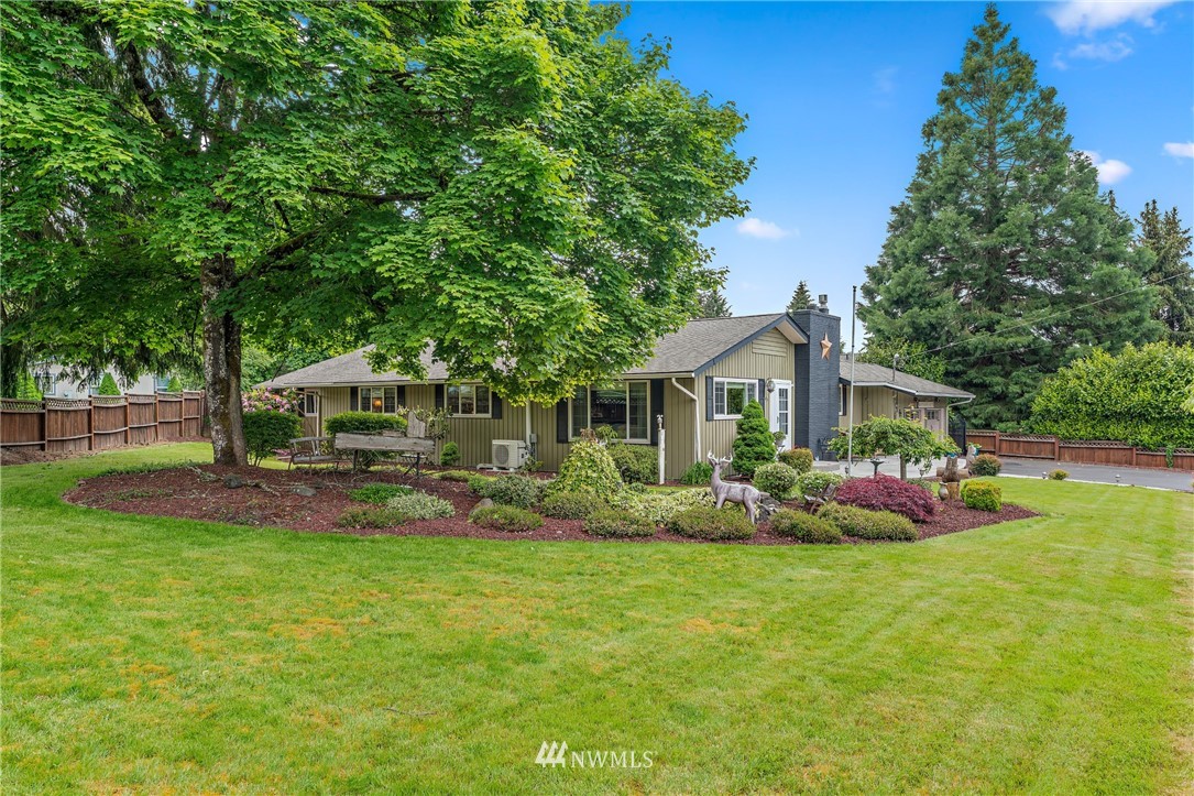 105 Ribelin Road Chehalis, WA 98532 - Photo 2 of 27 a front view of a house with a garden and trees