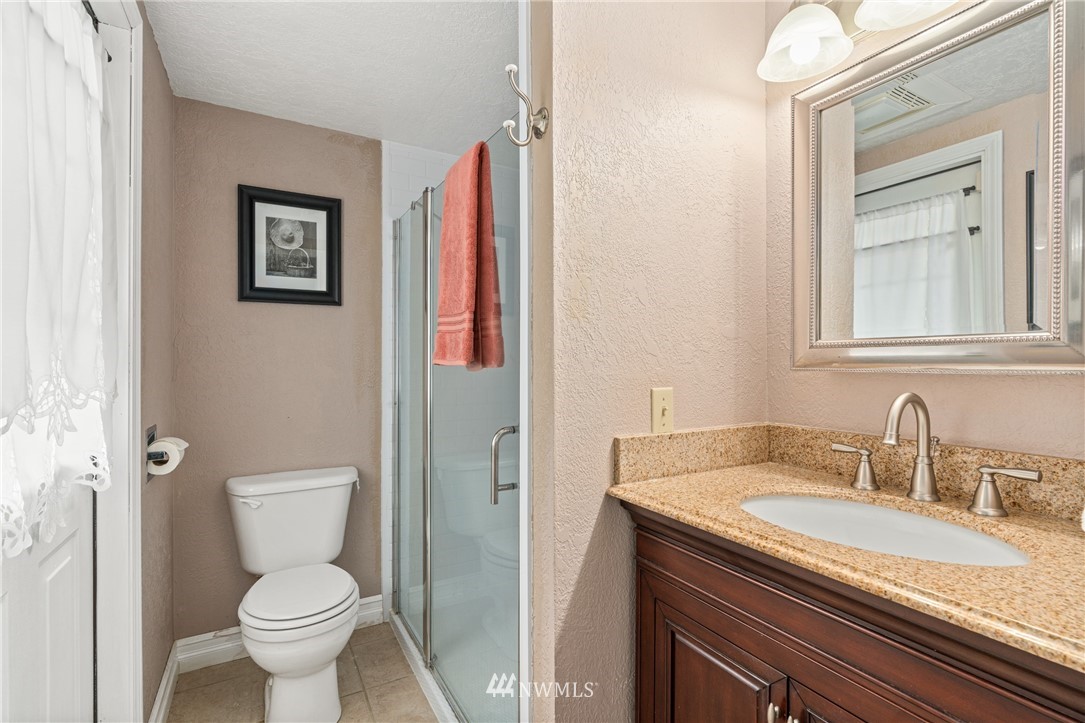 105 Ribelin Road Chehalis, WA 98532 - Photo 16 of 27 a bathroom with a granite countertop sink toilet and a mirror