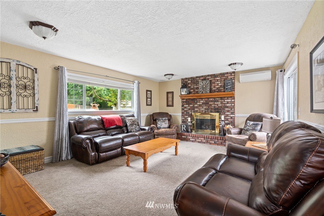 105 Ribelin Road Chehalis, WA 98532 - Photo 19 of 27 a living room with furniture a fireplace and a flat screen tv