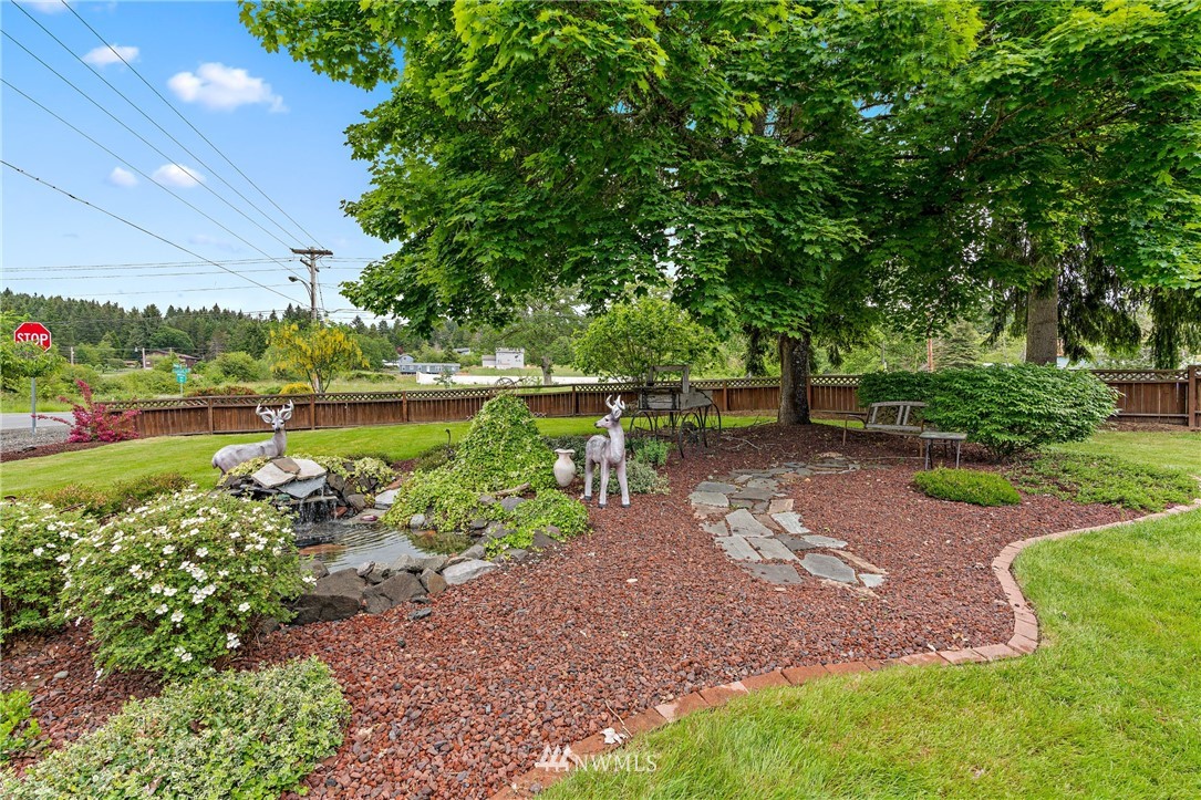 105 Ribelin Road Chehalis, WA 98532 - Photo 3 of 27 a backyard of a house with a garden and outdoor seating