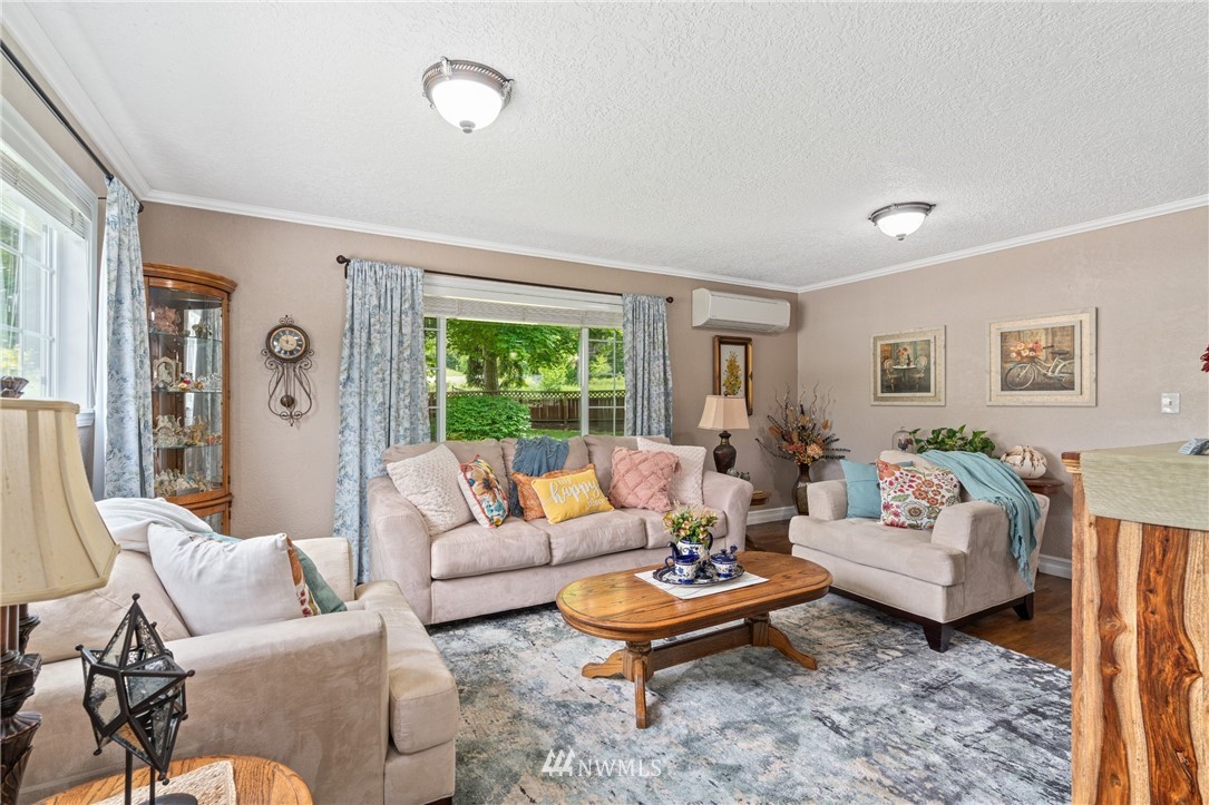 105 Ribelin Road Chehalis, WA 98532 - Photo 6 of 27 a living room with furniture a rug and a large window