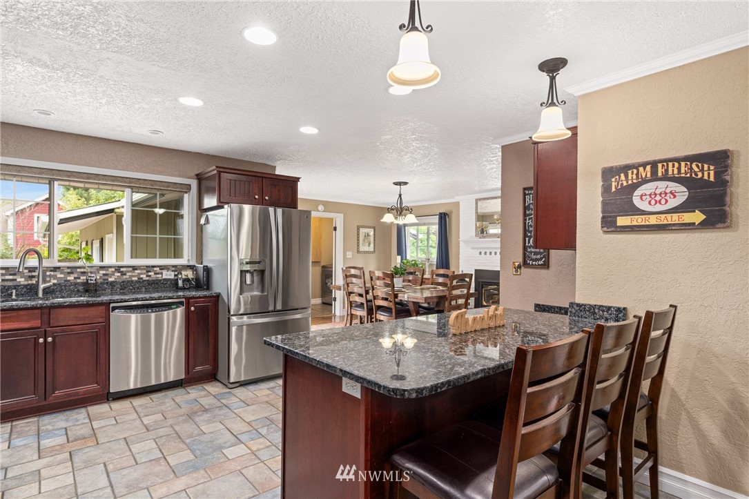 105 Ribelin Road Chehalis, WA 98532 - Photo 8 of 27 a kitchen with stainless steel appliances granite countertop a sink a stove a dining table and chairs