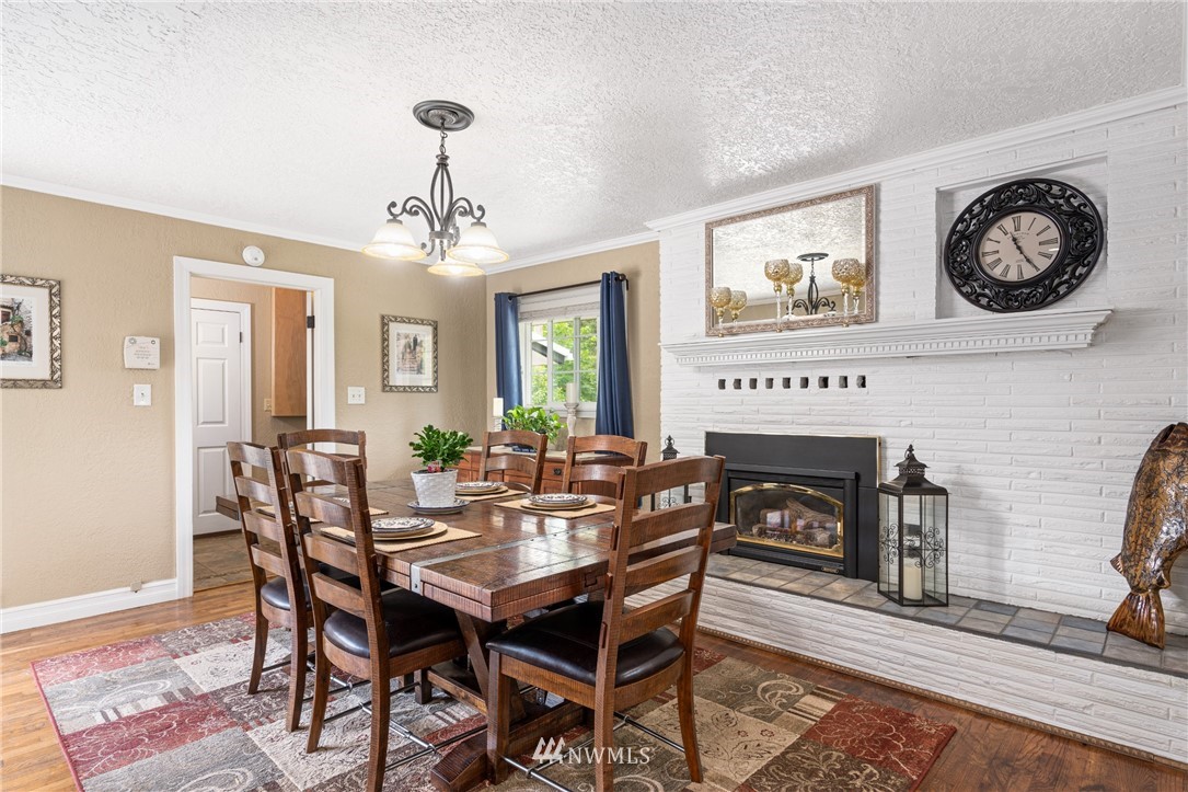 105 Ribelin Road Chehalis, WA 98532 - Photo 10 of 27 a view of a dining room with furniture and a fireplace