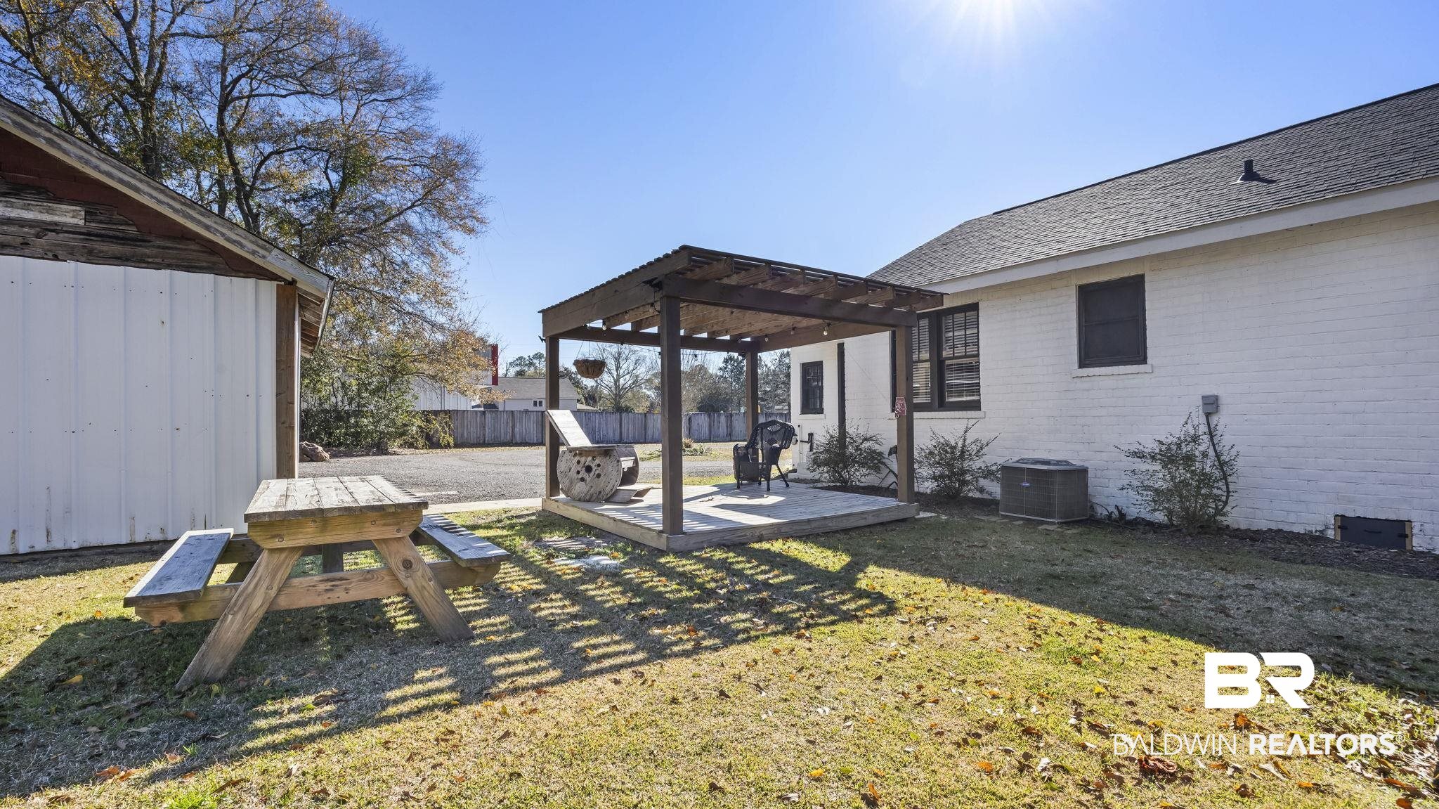 24701 Highway 98 Elberta, AL 36530 - Photo 20 of 32 Fenced backyard with a deck and a pergola