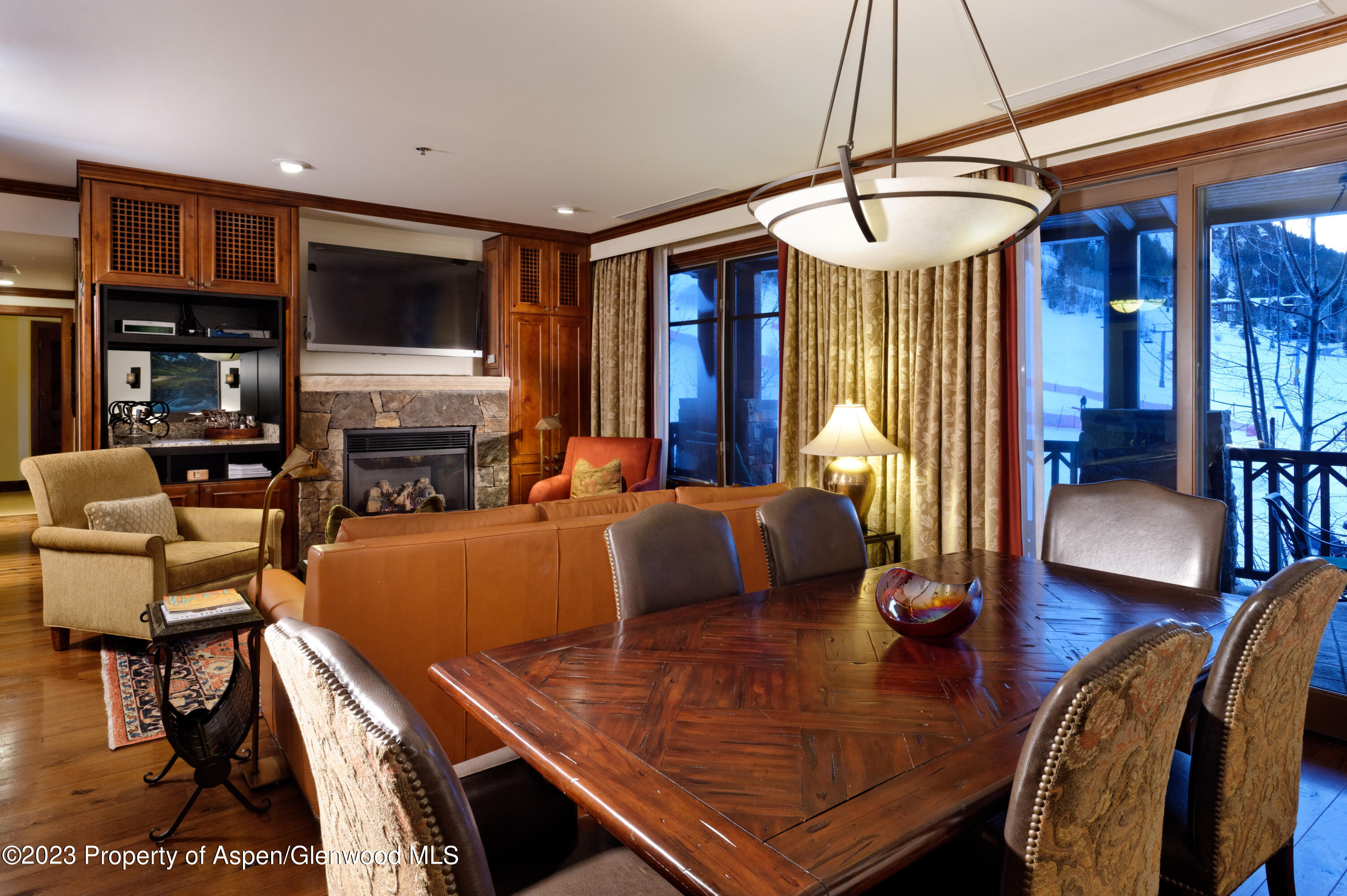 75 Prospector Road, Unit 840610 Aspen, CO 81611 - Photo 8 of 29 a view of a dining room with furniture window and wooden floor