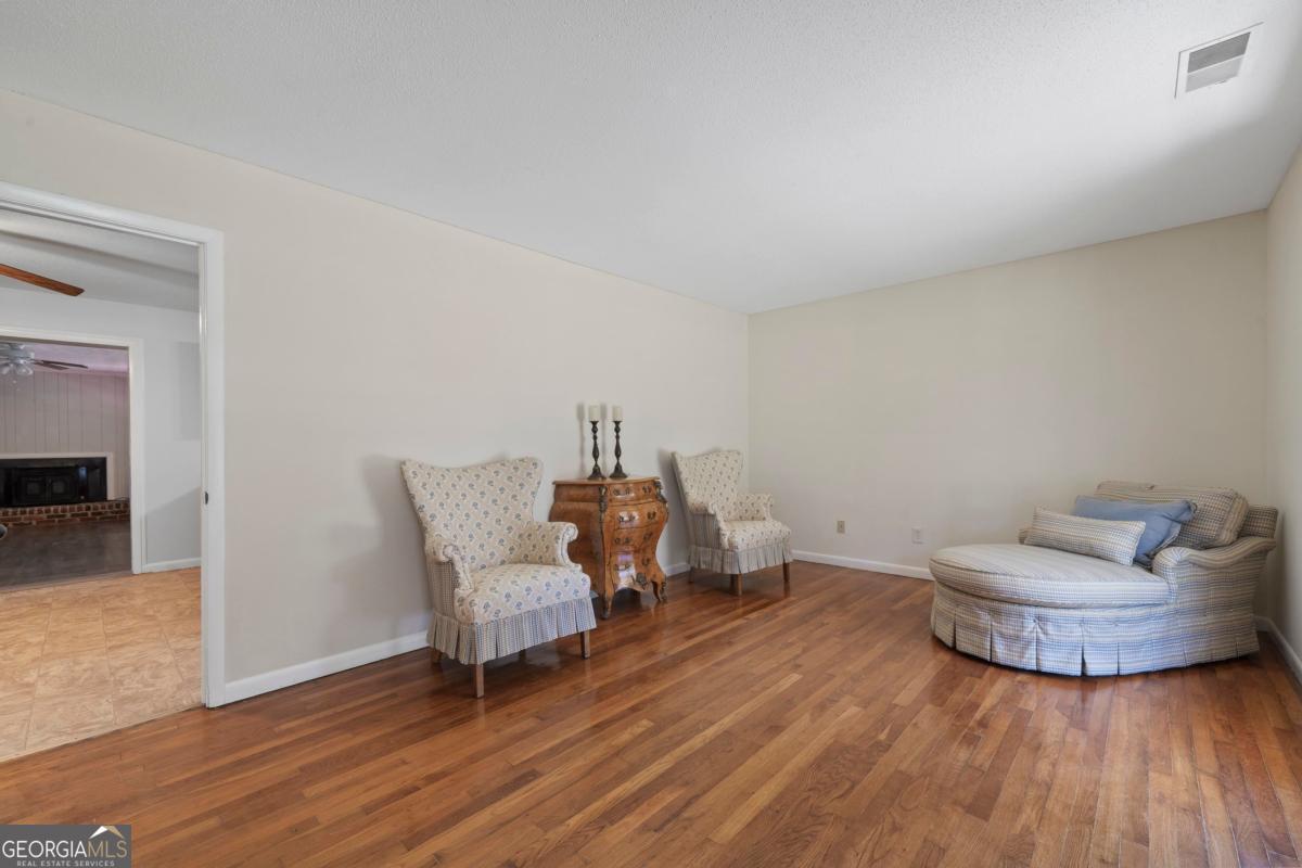 3021 Penfield Road Greensboro, GA 30642 - Photo 13 of 50 a living room with furniture and a wooden floor