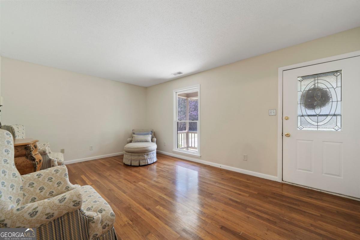 3021 Penfield Road Greensboro, GA 30642 - Photo 14 of 50 a bedroom with a bed and wooden floor