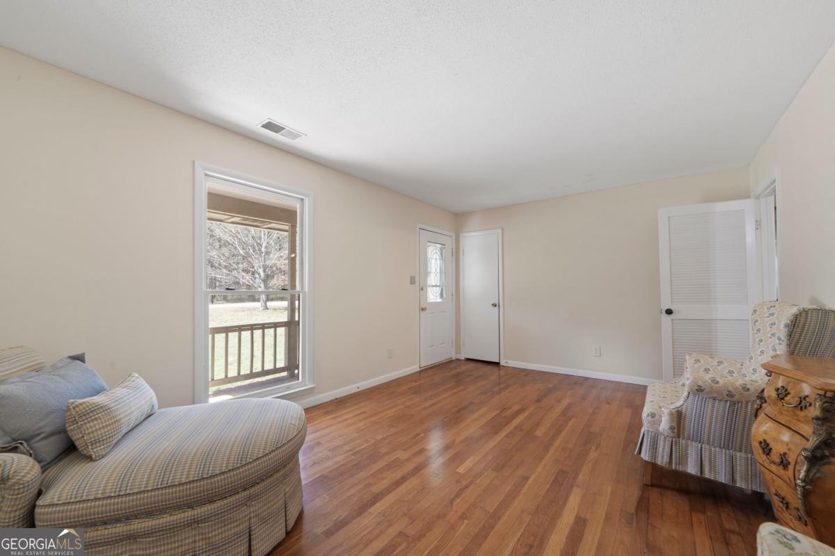 3021 Penfield Road Greensboro, GA 30642 - Photo 15 of 50 a bedroom with furniture and a window