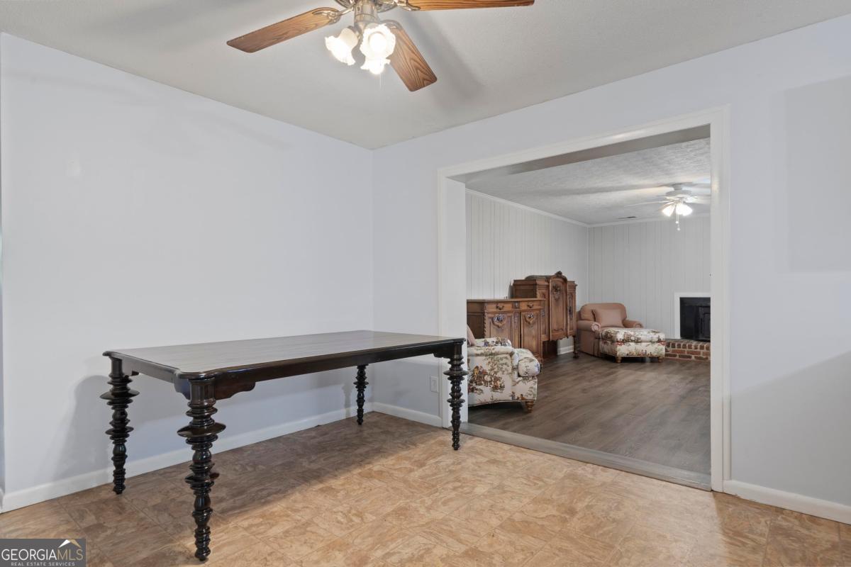 3021 Penfield Road Greensboro, GA 30642 - Photo 17 of 50 a living room with furniture and a chandelier