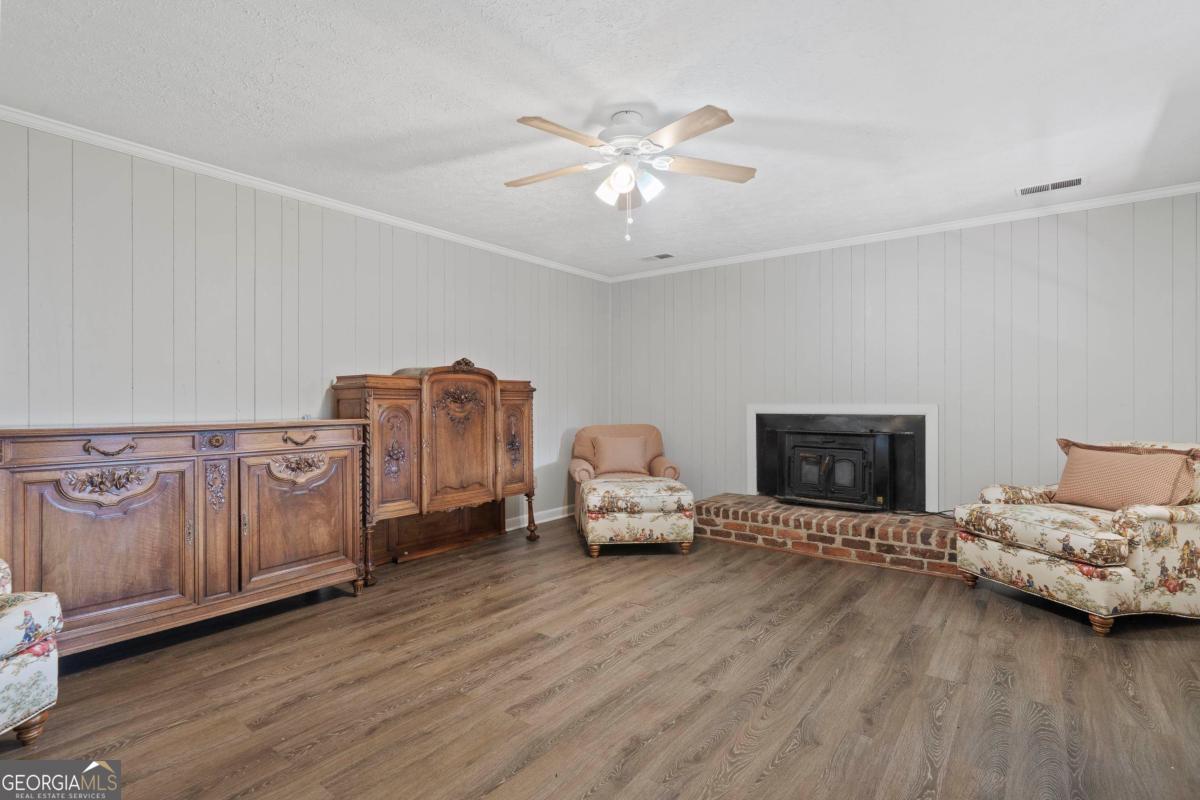 3021 Penfield Road Greensboro, GA 30642 - Photo 27 of 50 a living room with furniture and wooden floor