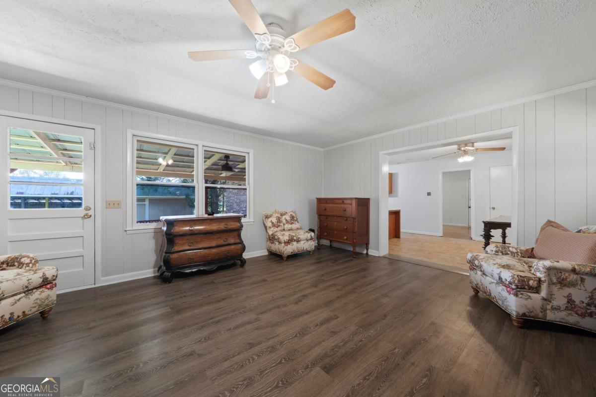 3021 Penfield Road Greensboro, GA 30642 - Photo 28 of 50 a living room with furniture and a wooden floor