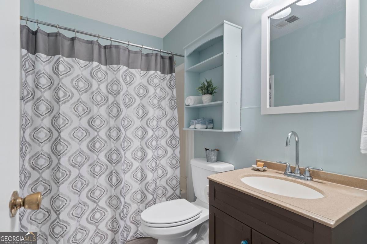 3021 Penfield Road Greensboro, GA 30642 - Photo 29 of 50 a bathroom with a sink toilet and shower