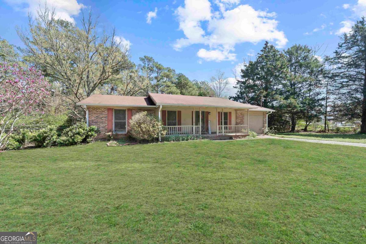 3021 Penfield Road Greensboro, GA 30642 - Photo 3 of 50 a front view of a house with a garden