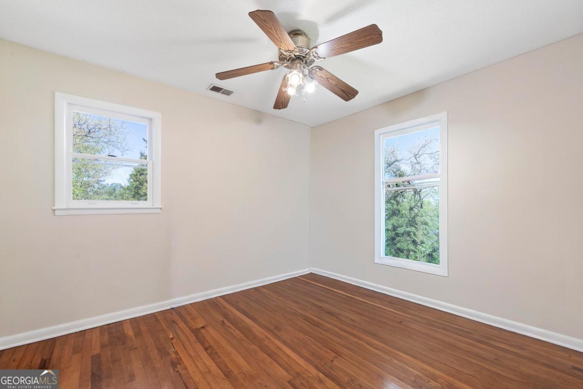 3021 Penfield Road Greensboro, GA 30642 - Photo 34 of 50 a view of an empty room with wooden floor and a window