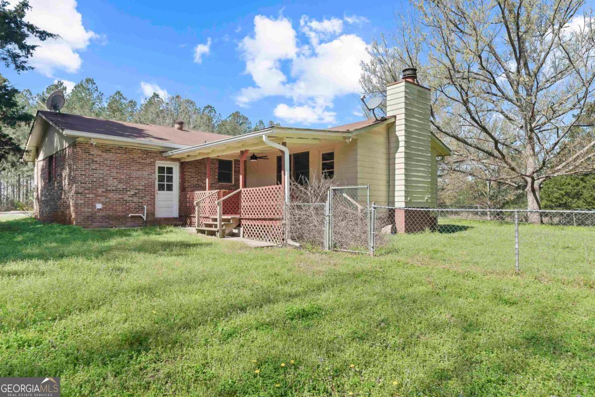 3021 Penfield Road Greensboro, GA 30642 - Photo 5 of 50 a view of a house with a backyard
