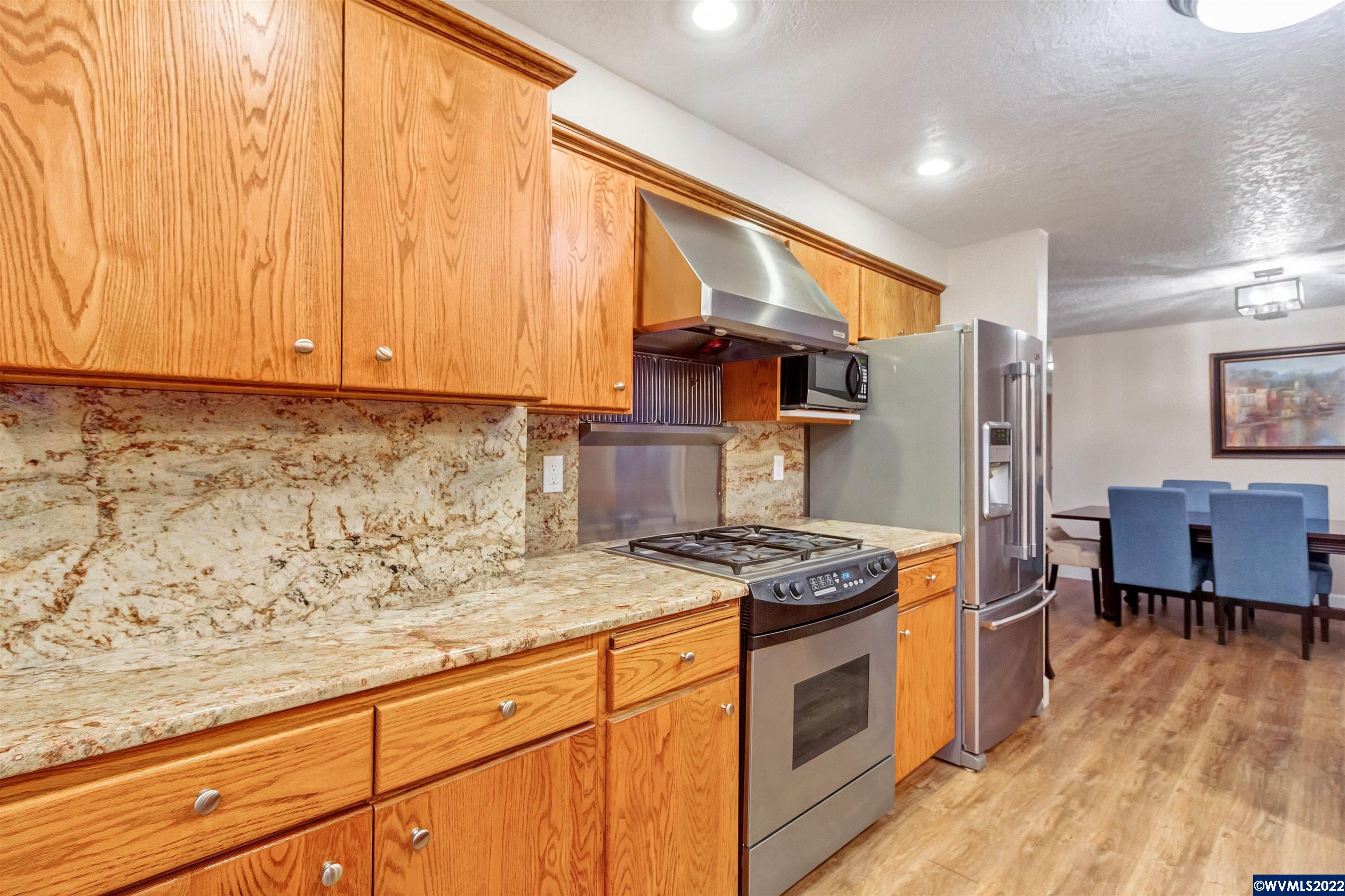 150 Edwards Road South Monmouth, OR 97361 - Photo 10 of 39 a kitchen with stainless steel appliances granite countertop a stove a refrigerator and a microwave