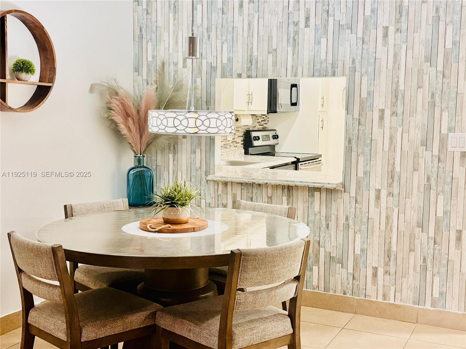 8350 Sands Point Boulevard, Unit E104 Tamarac, FL 33321 - Photo 13 of 13 a dining room with furniture and a window